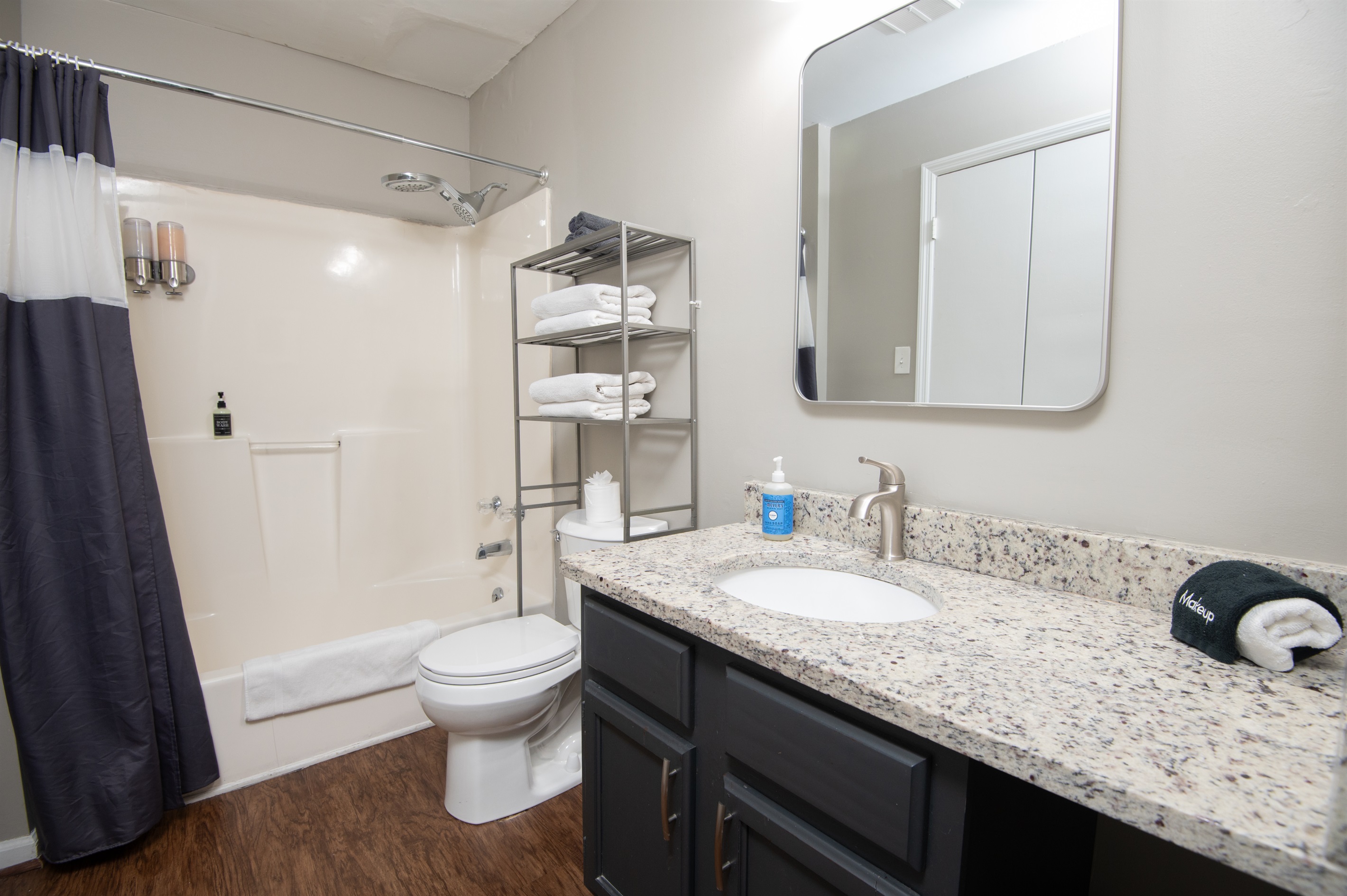 Here is Unit C's first full-sized bathroom located in the hallway. Bath and shower mix! Bring your favorite bubble bath! Both bathrooms come complete with shampoo, body wash, conditioner, hand soap, and all the linens you need for a comfy stay.