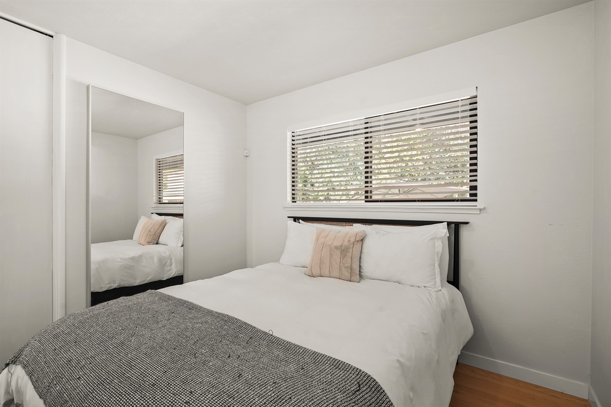 Well-appointed bedroom featuring a queen bed and relaxing ambiance, perfect for couples, friends, or family members.