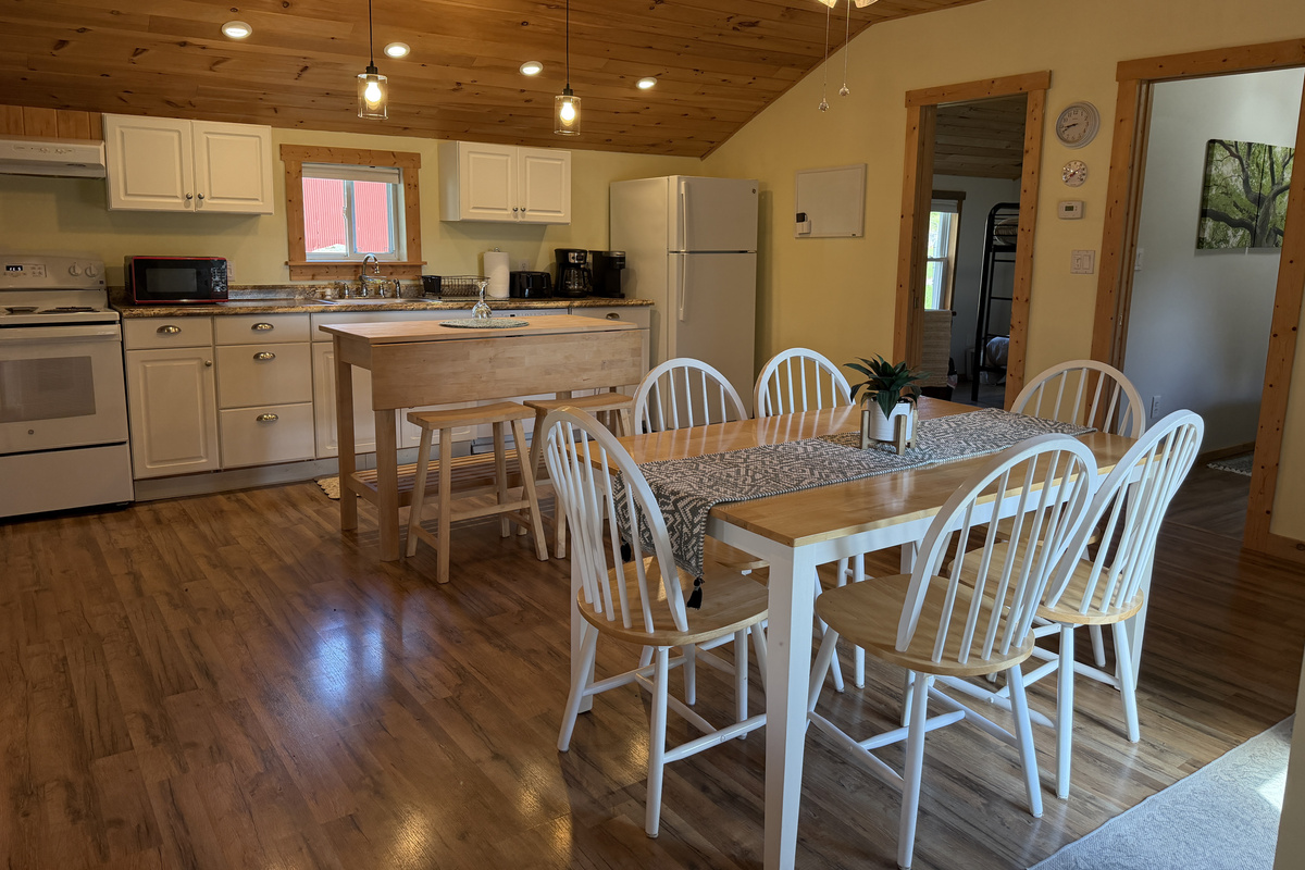 Dining and kitchen with bedrooms on the right