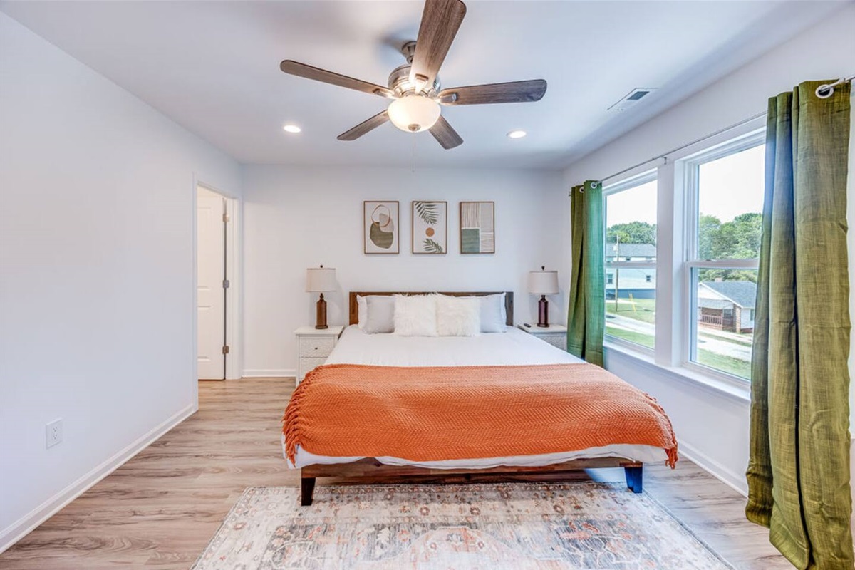 Relax in the spacious bedroom featuring a comfortable king bed, with a private master bathroom attached for added convenience and comfort.
