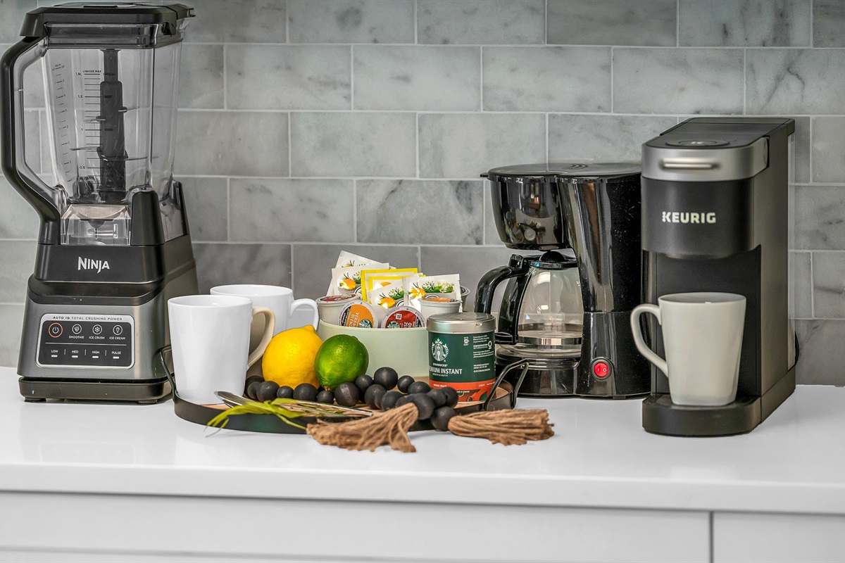 The fully stocked kitchen boasts a Sub-Zero fridge and acacia wood butcher block counters. A peninsula with seating provides the perfect spot for casual meals or morning coffee.