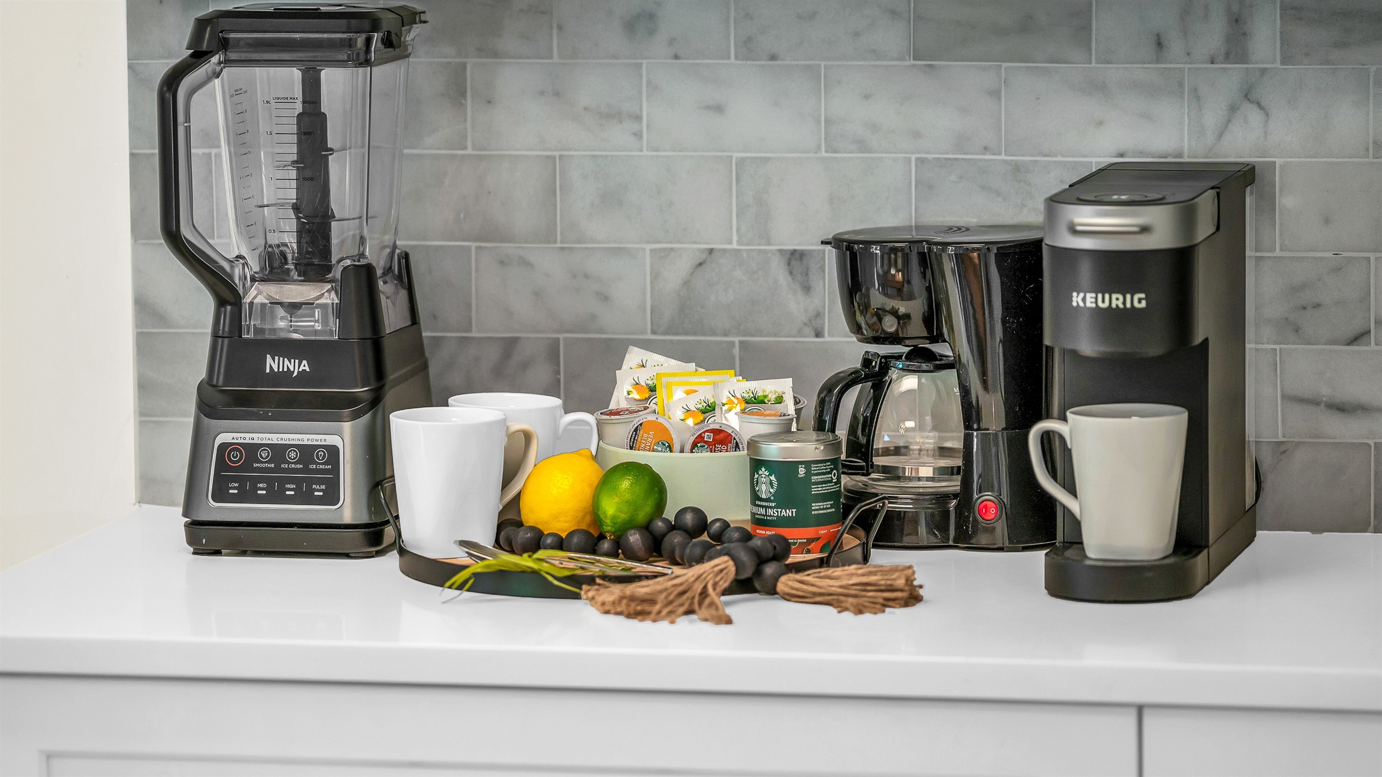 The fully stocked kitchen boasts a Sub-Zero fridge and acacia wood butcher block counters. A peninsula with seating provides the perfect spot for casual meals or morning coffee.