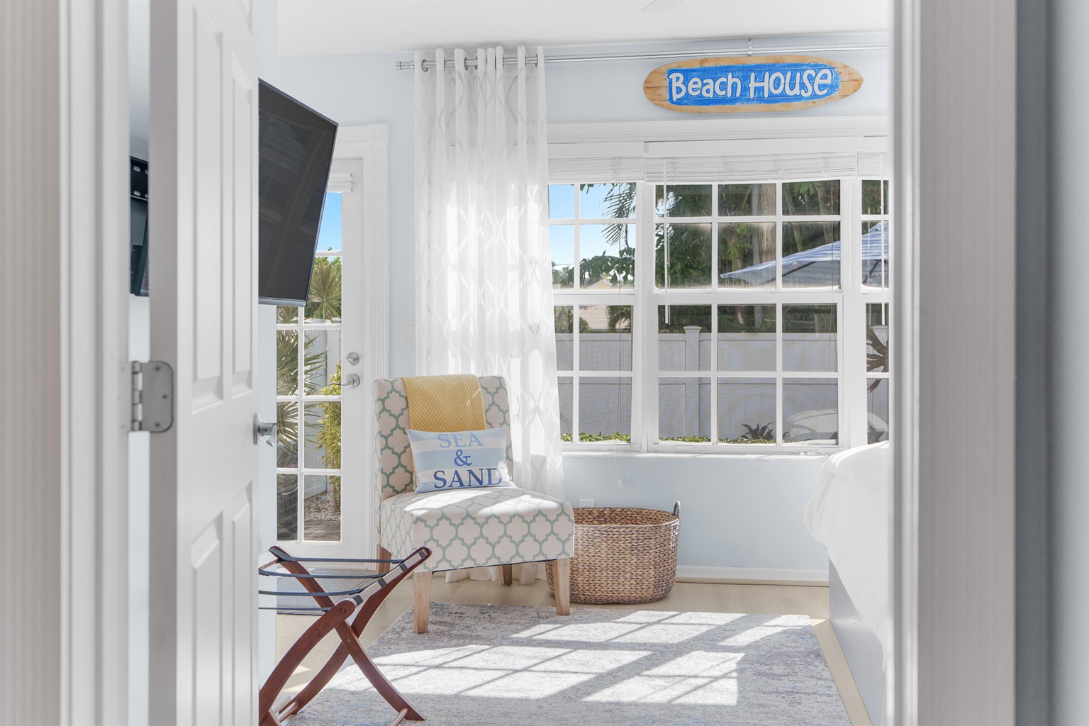 Master suite, with luggage rack, flat screen TV, and back patio access