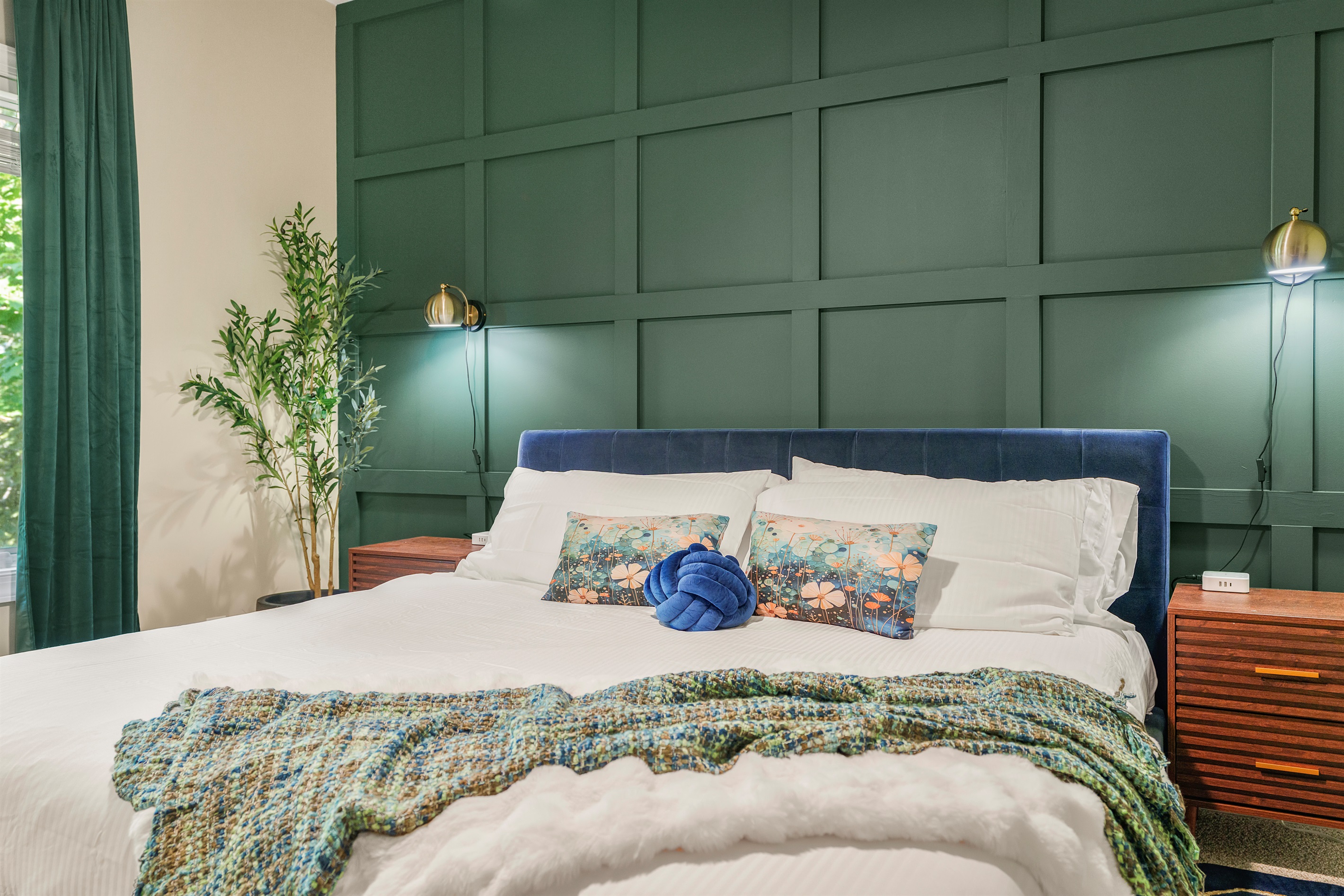 Relax in this peaceful king suite—lush textiles, bold green paneling, soft mood lights