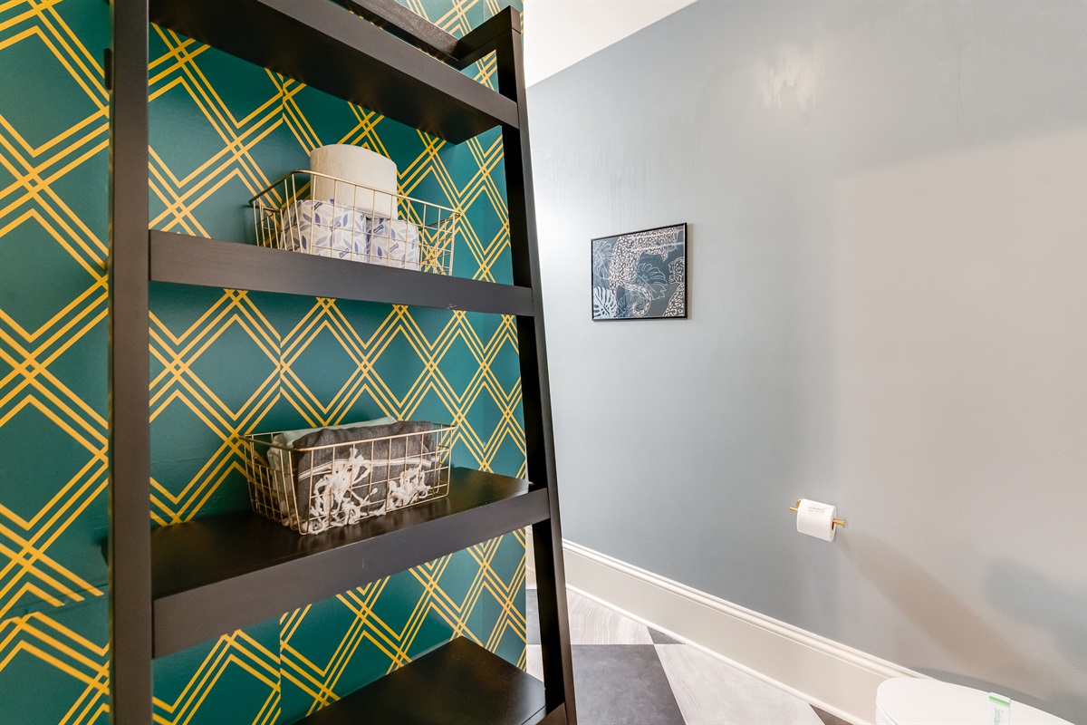 Ensuite to BR2: Vibrant patterned walls and stylish shelving for a fun touch! 