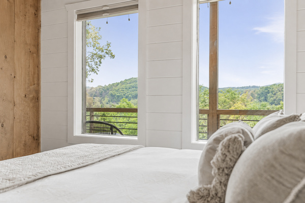 Unwind in comfort with a ceiling fan and 55” wall-mounted TV. This bedroom also includes a private closet equipped with a box fan and luggage rack — perfect for white noise and convenient unpacking after your travels.