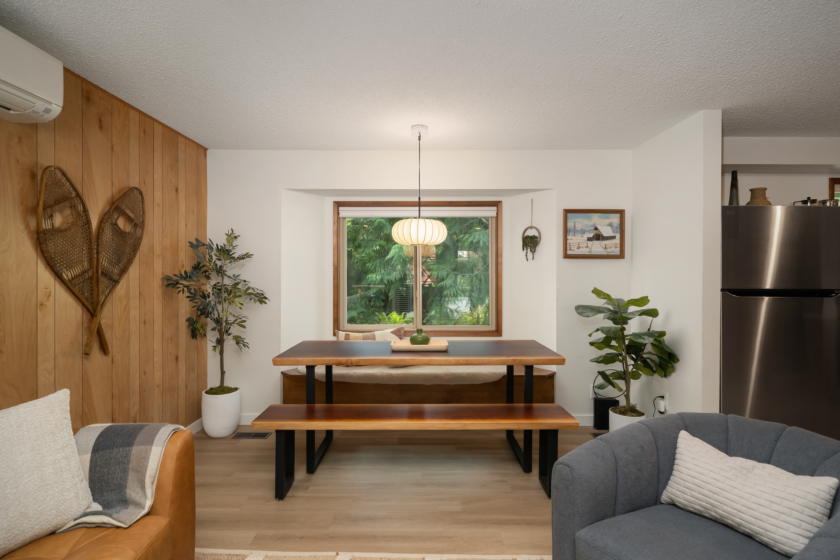 A cozy dining nook under vintage snowshoes — pull up the bench and dig in.