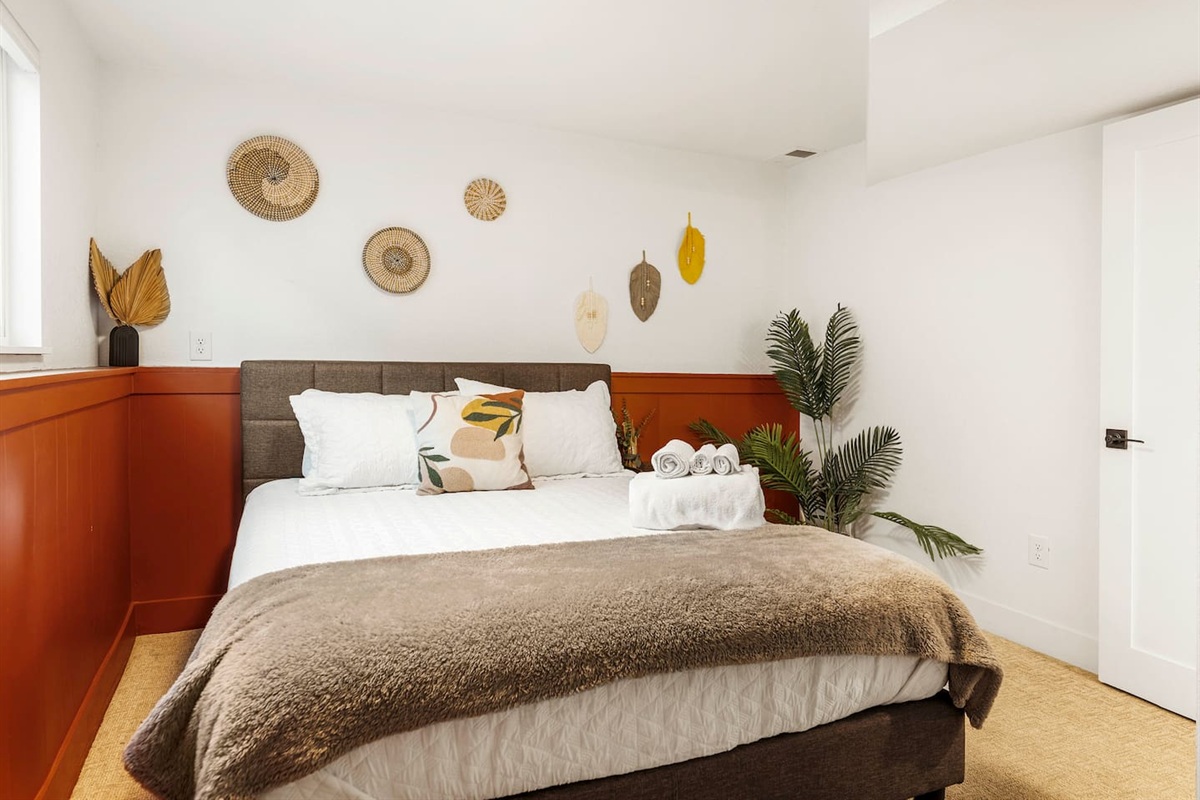 Queen lower level room with chic design and a full desk for those nomadic workers or anyone needing a workspace. 