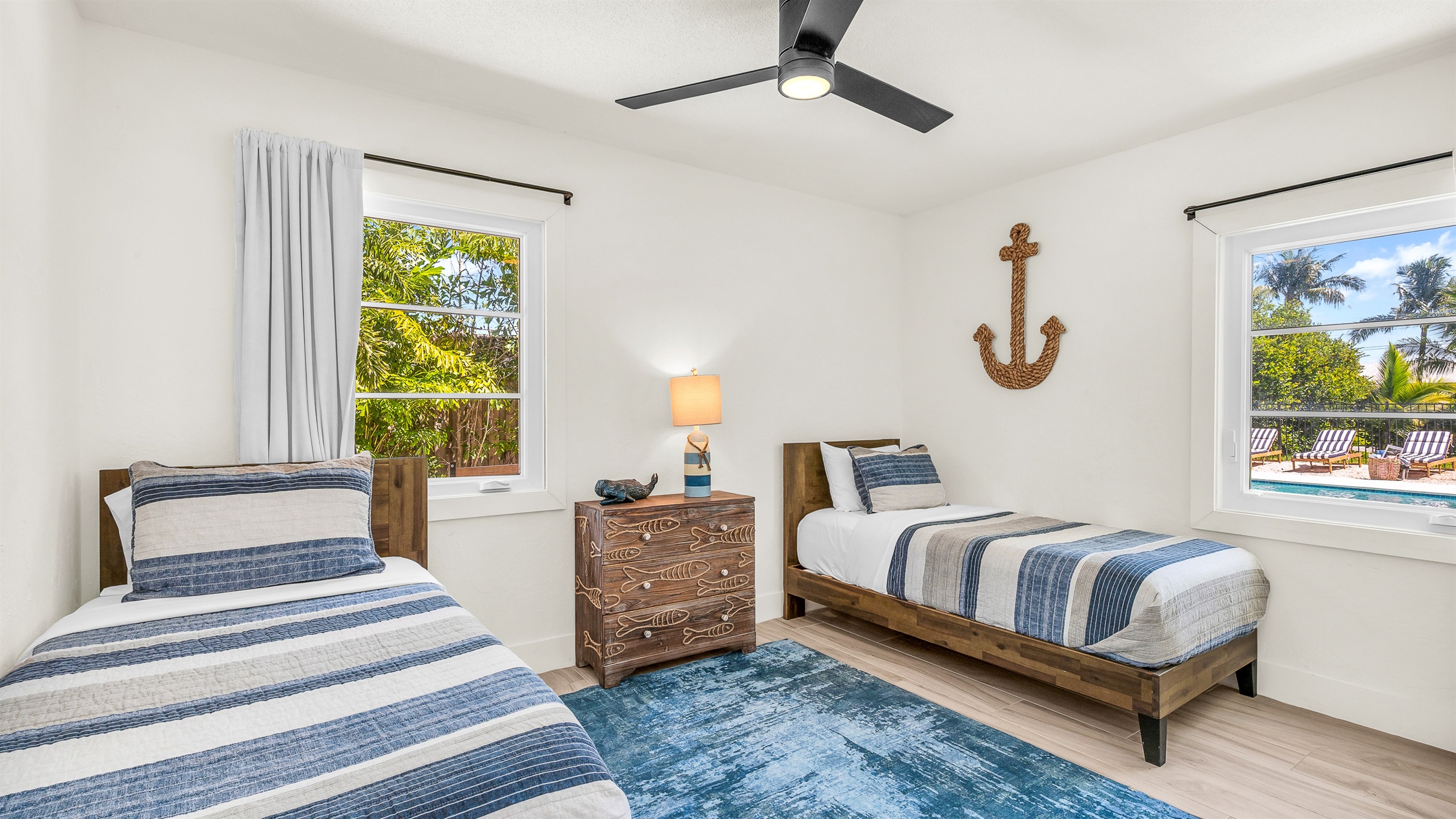 Bedroom 4 features cozy twin beds with nautical-inspired decor and soft coastal tones, perfect for kids, friends, or guests seeking a bright and cheerful space to unwind.
