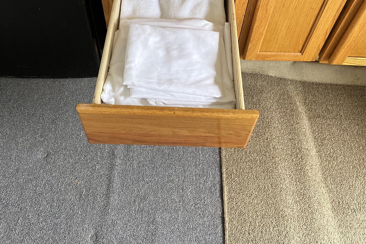 Extra sheets and towels are found in the cabinets.