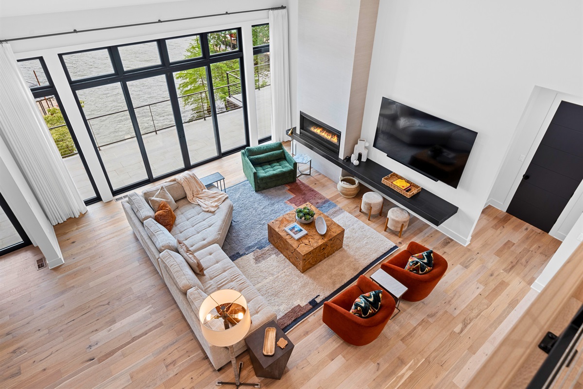 This living room is designed for relaxation and stylish entertaining. The modern furnishings and vibrant accents create a warm and inviting atmosphere.