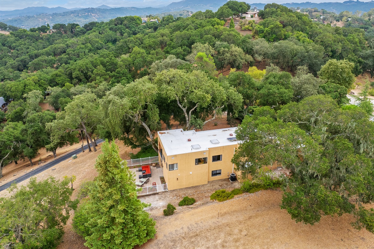 Modern hillside hideaway nestled in the treetops, with sweeping mountain views in every direction.