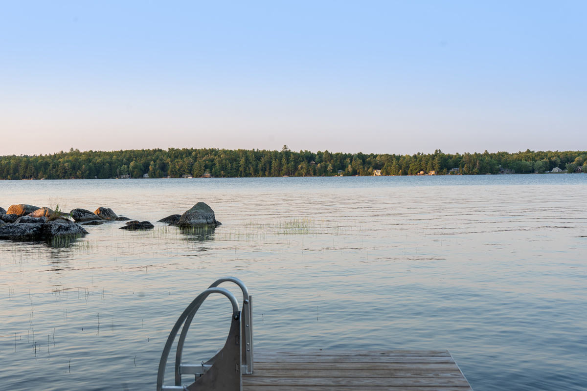 Wide water views from the private dock at Loonrise Point! Swim ladder offers easy lake access next to natural granite rock outcroppings in Beech Hill Pond. Prime spot for fishing, watching loons, or swimming in Otis, ME.
