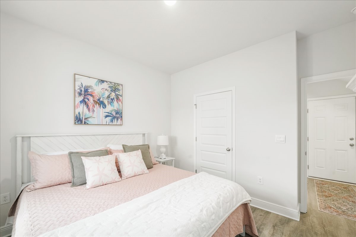 Enjoy your own space in King Suite 2, featuring a plush king bed, Smart TV, closet, seating chair, and luggage stand for a comfortable and private stay.