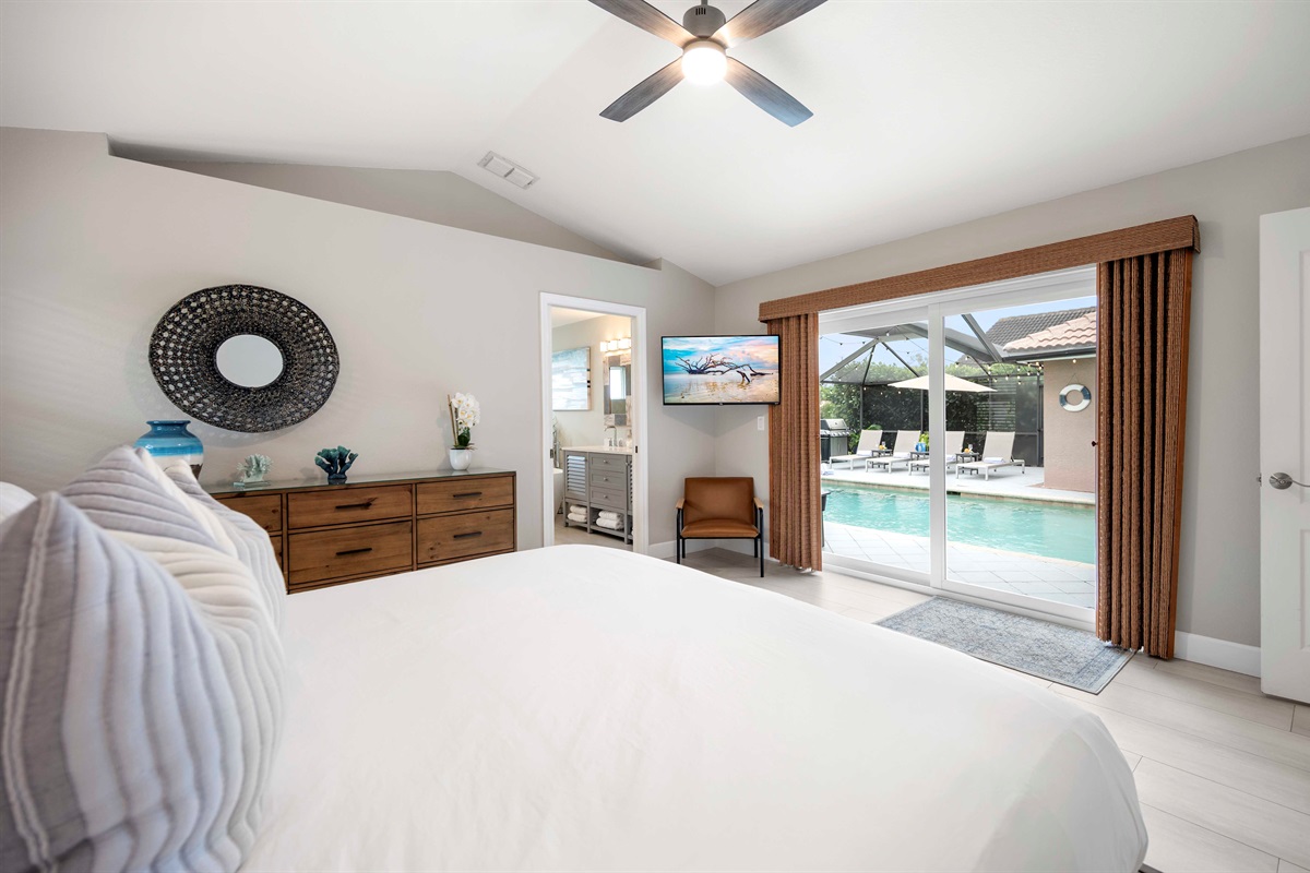 Master bedroom with private sliding doors to the pool—morning dips, anyone?