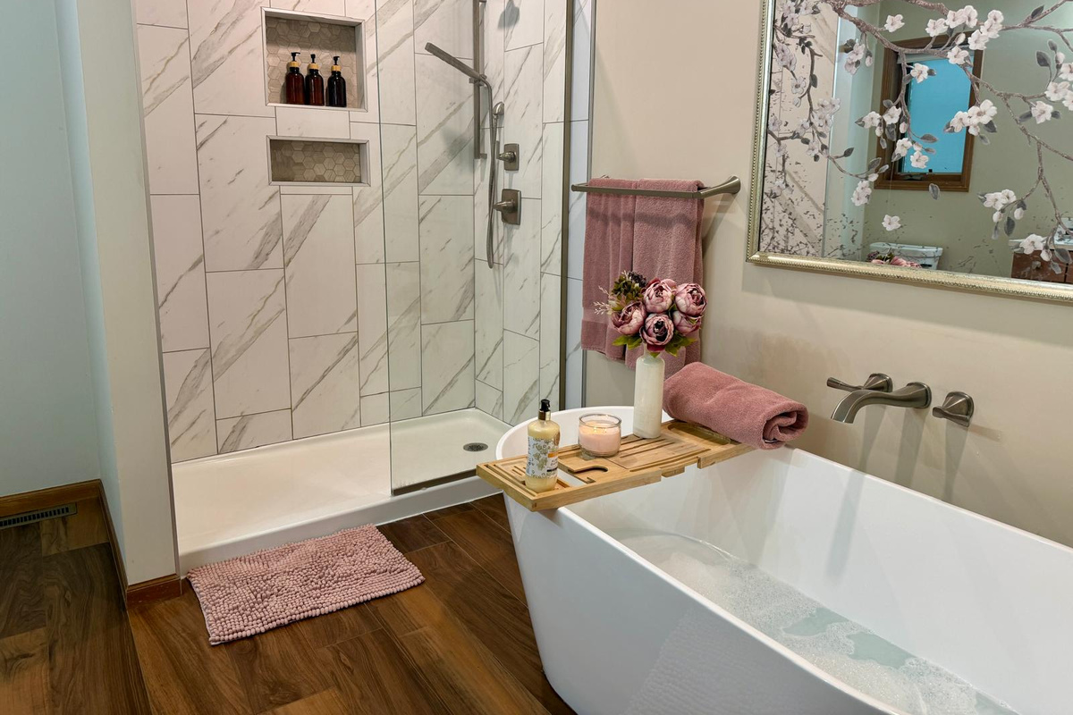 Gorgeous soaking tub on main level, and shower, in primary bathroom