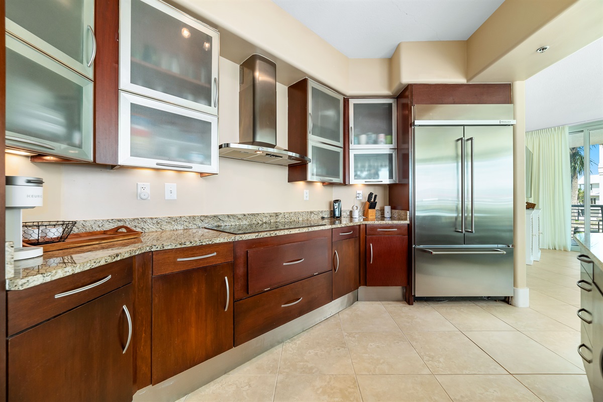 This gourmet kitchen, featuring stainless steel appliances and granite countertops, seamlessly flows into the spacious living area, perfect for entertaining and enjoying breathtaking views.