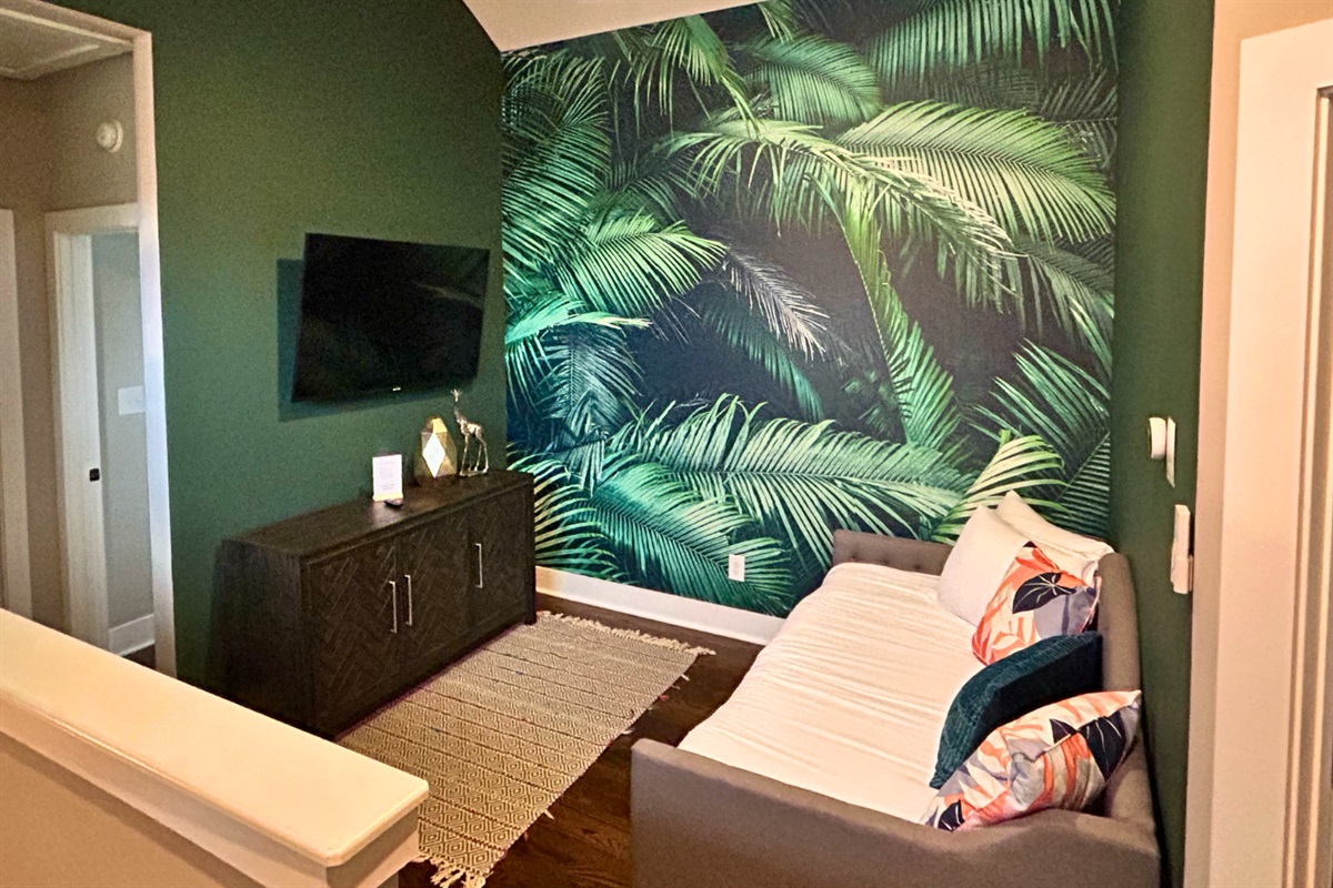 - Lounge out in this tropical inspired nook with bold palm vibes and comfy seating - Catch up on shows or sneak in a nap beneath the leafy wall art - Whether it’s chill time or screen time, this space makes it feel like a staycation