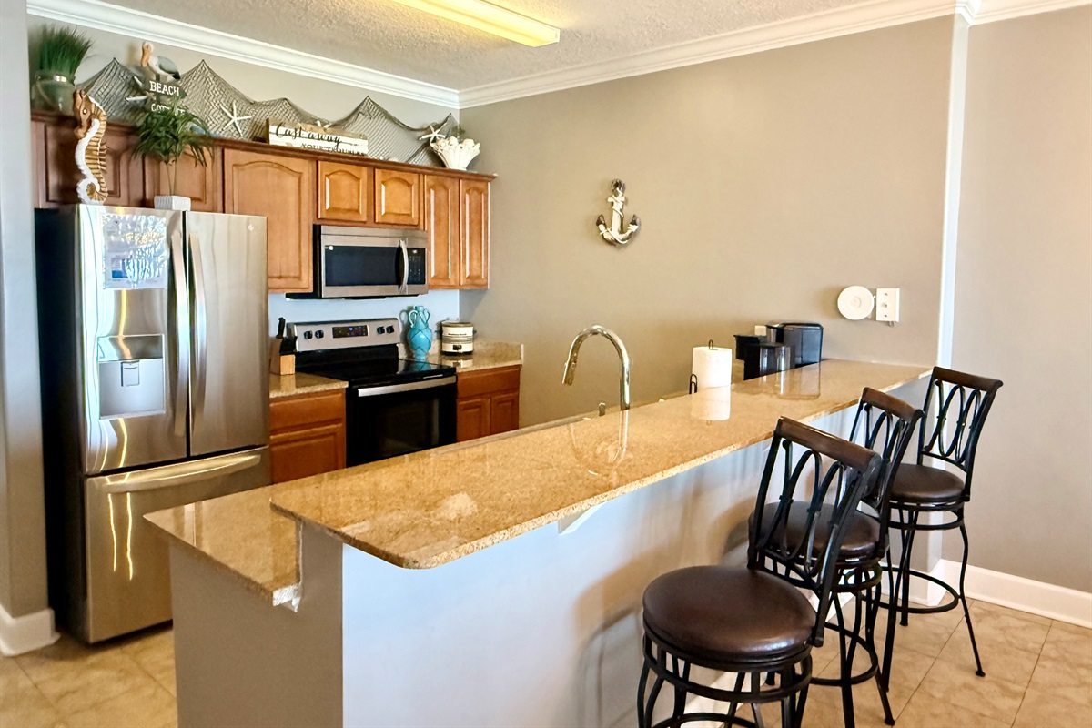 Fully Equipped Kitchen—Granite counters, new stainless steel appliances, breakfast bar seating, and both regular & K-Cup coffee makers!