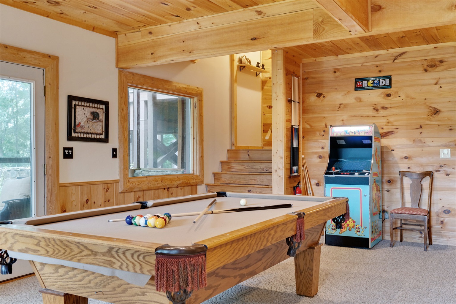 Basement game room has pool table and classic arcade game with 60+ games.  Not shown is the pinball machine, sitting area and kitchenette.