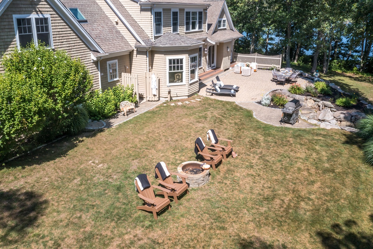A full layout of lakeside living—grill, firepit, seating, and the water just steps away.
