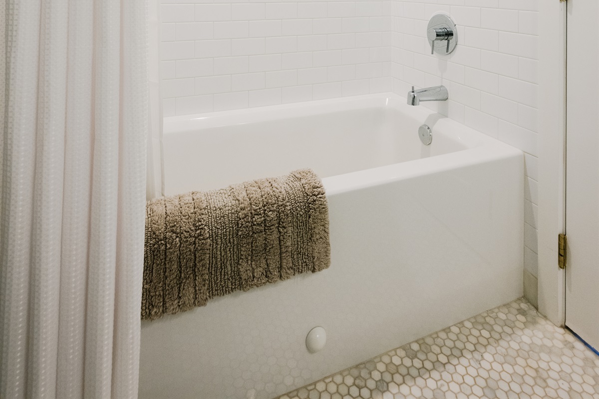 Shared full bathroom in Cookhouse: tub/shower combo.