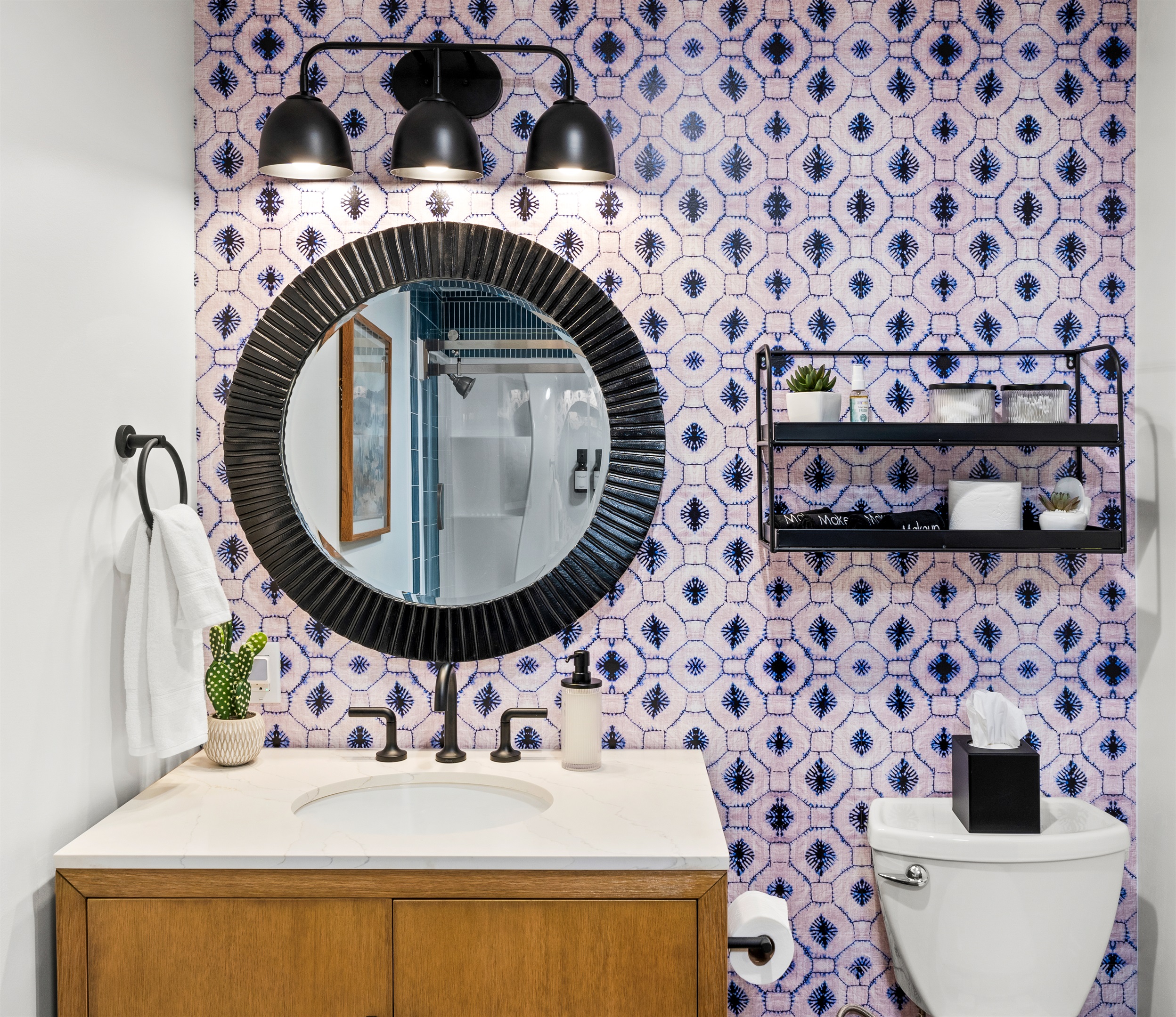 Charming bathroom with spacious tub and shower with bold wallpaper and modern fixtures.