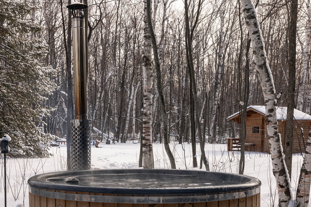 Hot tub in the winter looking toward the Sauna