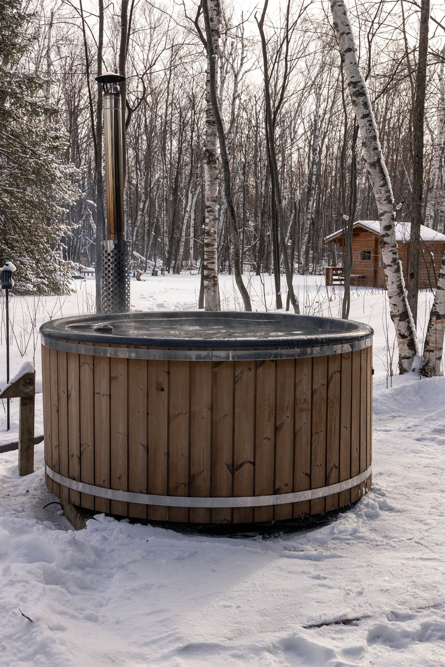 Hot tub in the winter looking toward the Sauna