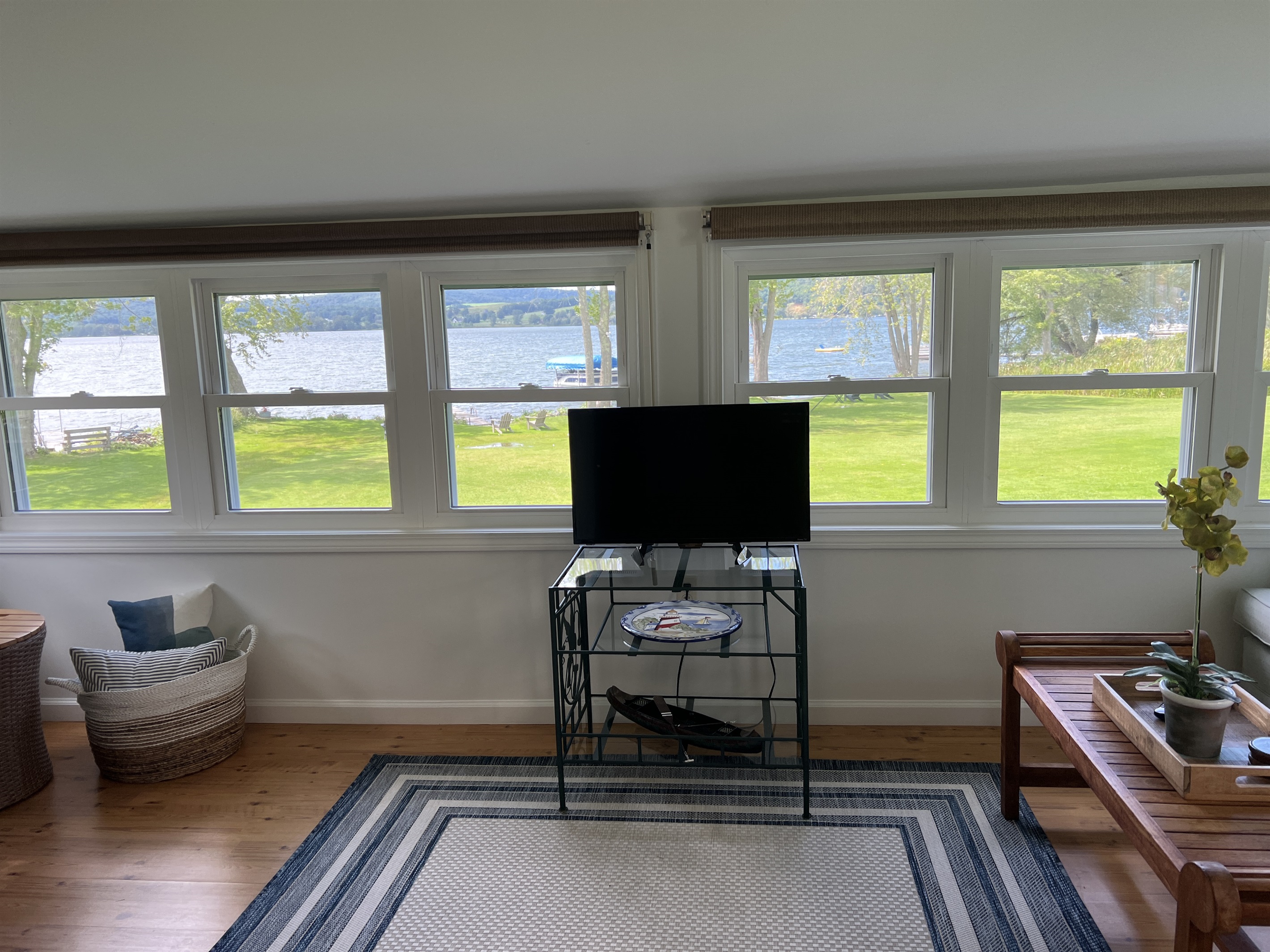 Sunroom overlooking lawn and lake