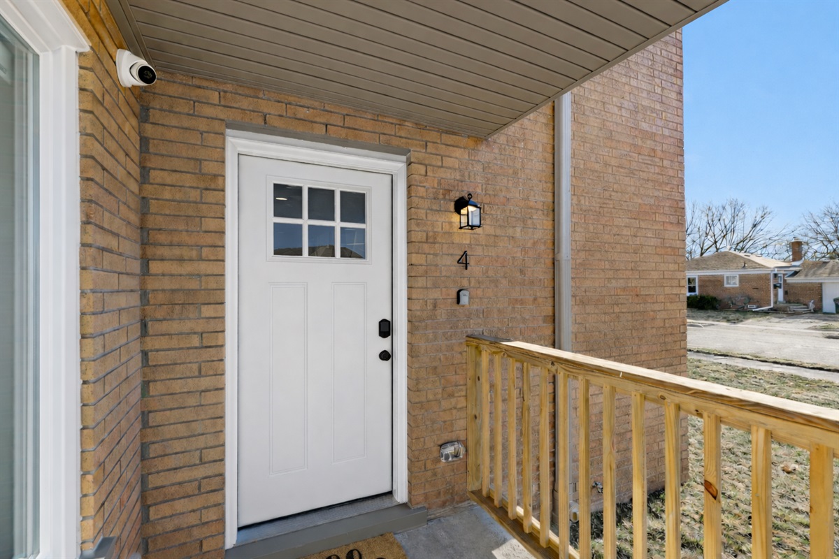 Inviting private entry with a covered porch, secure smart lock, and soft exterior lighting—welcoming you home with charm, comfort, and easy access.