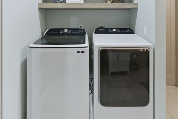 In-unit washer and dryer with open shelving for added convenience during your stay