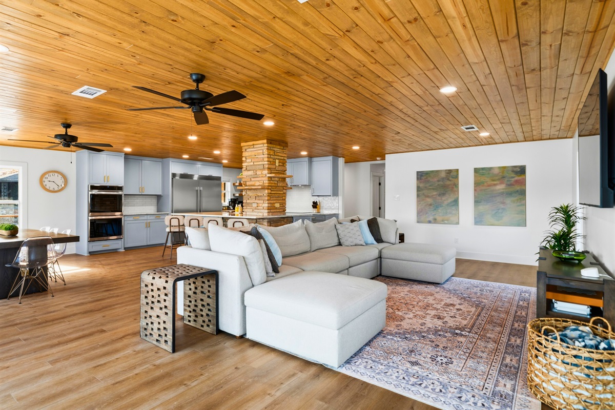 The open floor plan flows effortlessly between the living room and kitchen, creating a comfortable space for gathering, cooking, and spending time with family and friends.