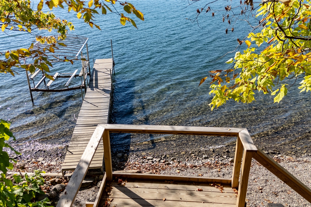 Small dock and steps into water — private lake-access for guests.
