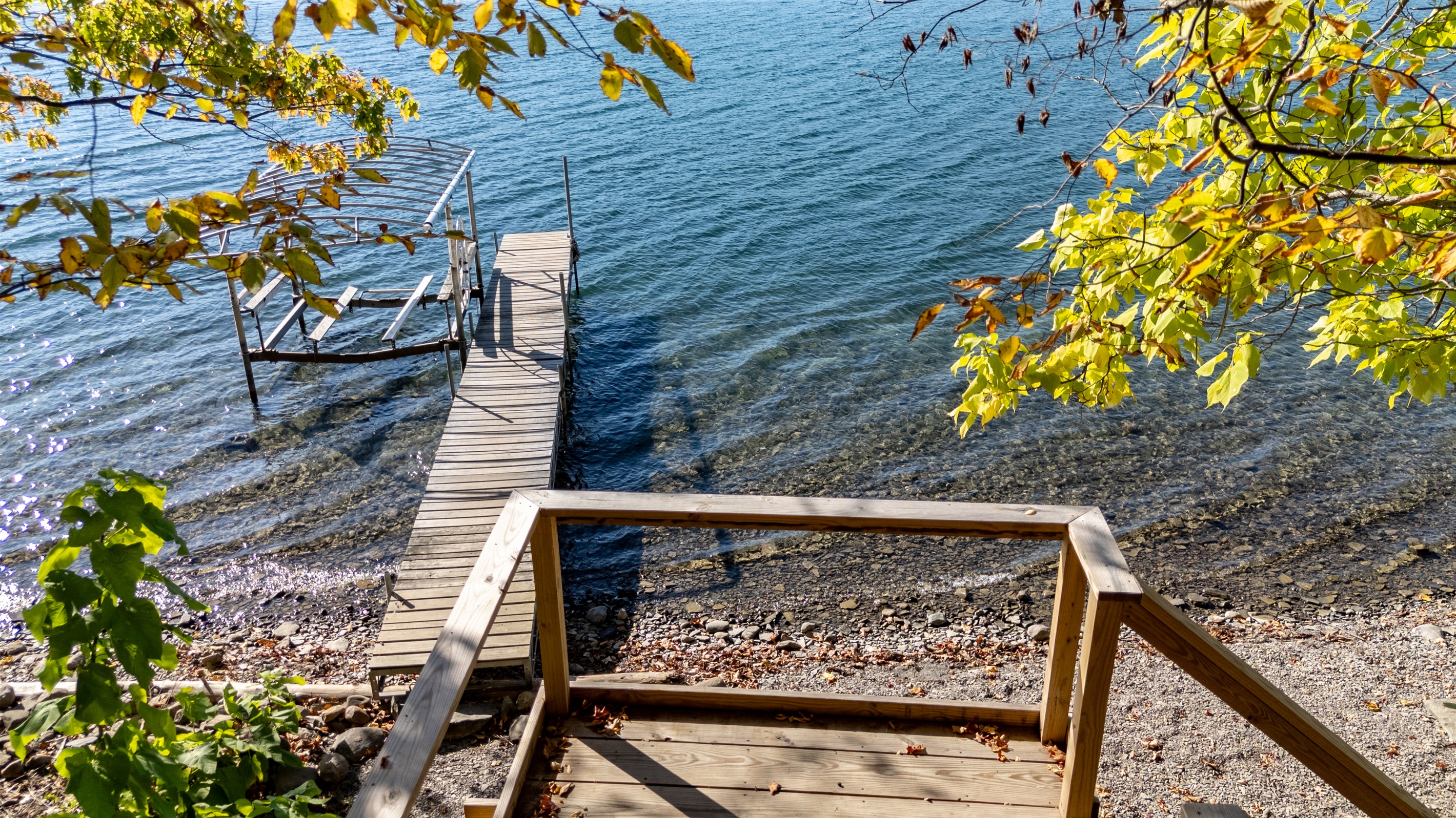Small dock and steps into water — private lake-access for guests.