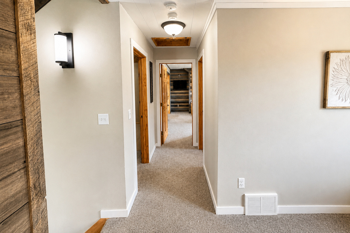 Off the steps the hallway connects two bedrooms and a bathroom. 
