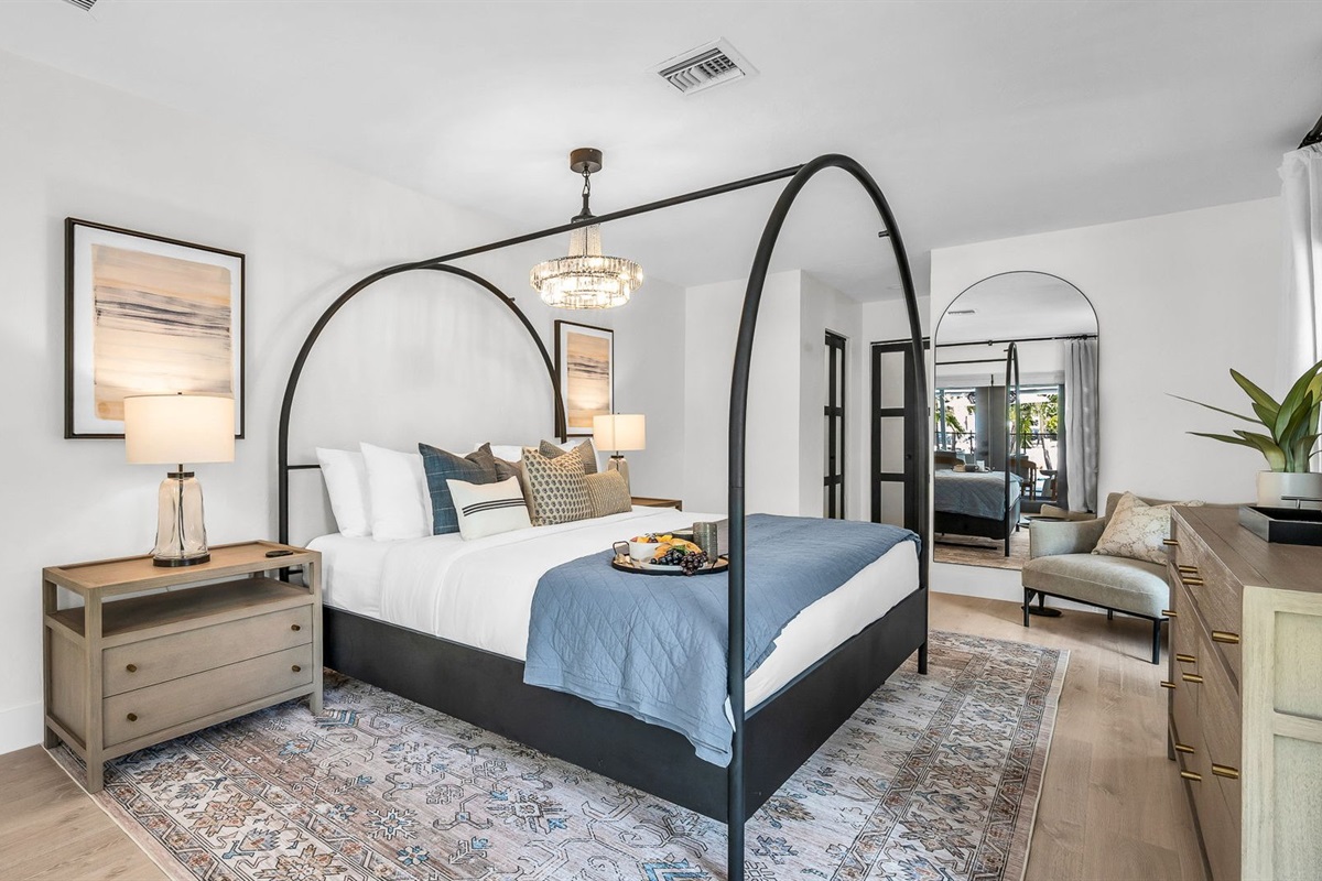 This second primary suite offers a plush king bed, private ensuite bathroom, and walk-in closet for added comfort. Enjoy poolside views and direct access to the outdoor living area, making it the perfect blend of luxury and convenience.
