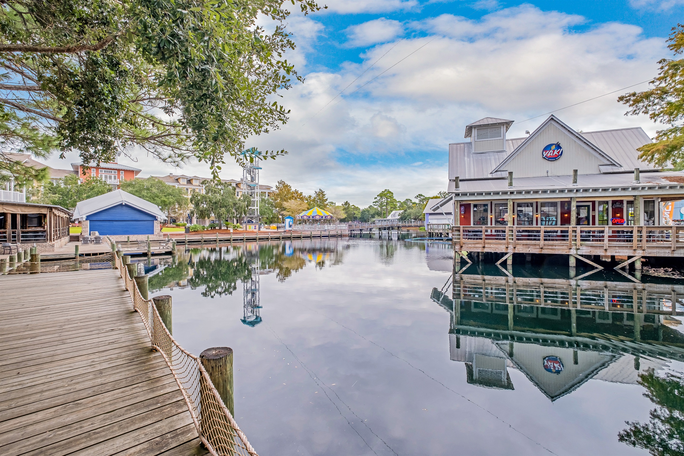 Stroll along the peaceful boardwalk next to a beautiful reflective lake, where you can find quaint shops and dining options overlooking the water.