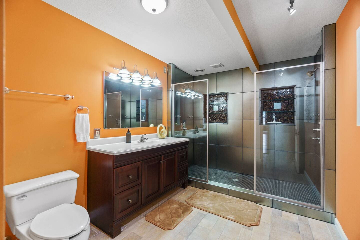 Full bathroom with modern fixtures, a spacious shower, and sleek finishes, providing a comfortable and functional space.