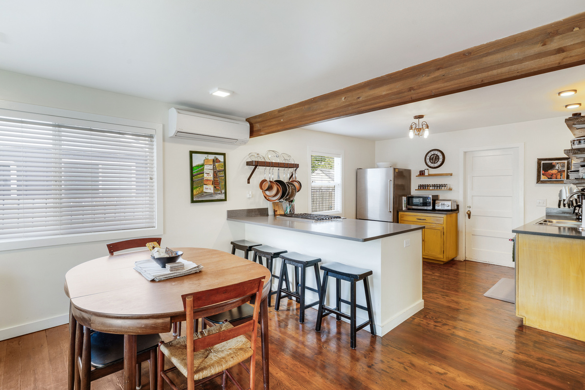 Dining table with seating for six. An additional four barstools pull up to the quartz island. 