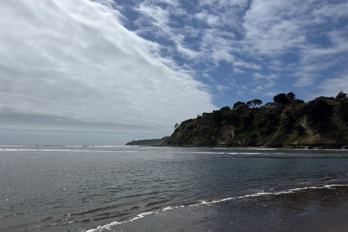 Scenic ocean view from the shoreline at the cliff base.

