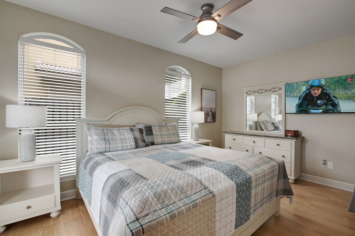  King bedroom with coastal bedding and natural light
