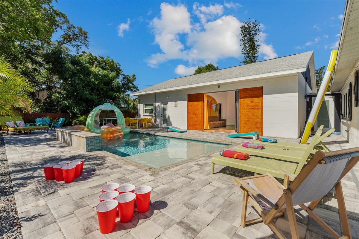 soak up the south Florida sun while watching the 150-inch LED TV through the massive slider door, surrounded by tropical landscaping by the heated salt water pool with LED waterfall, Funboy floats, cornhole & bucketball games, and smokeless firepit. 