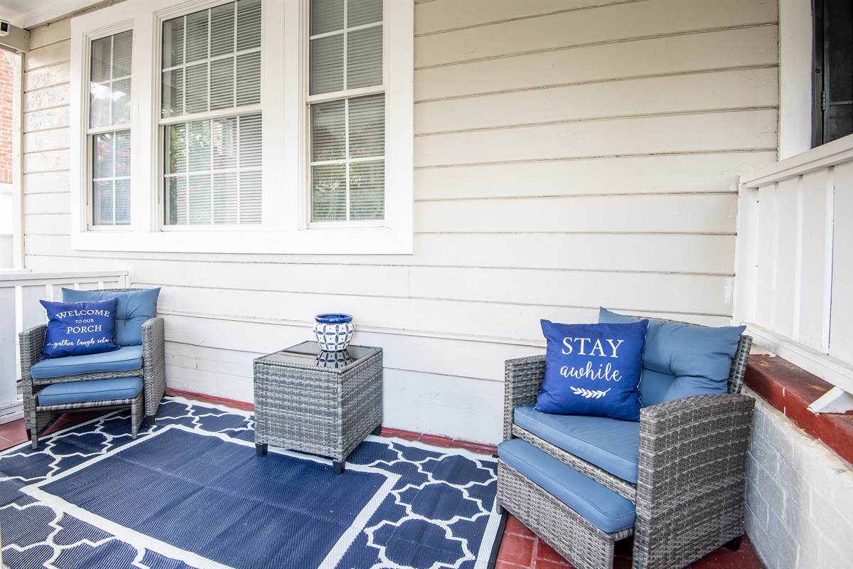 Unit B's inviting front porch with games and wooden stairs leading down to the unit.