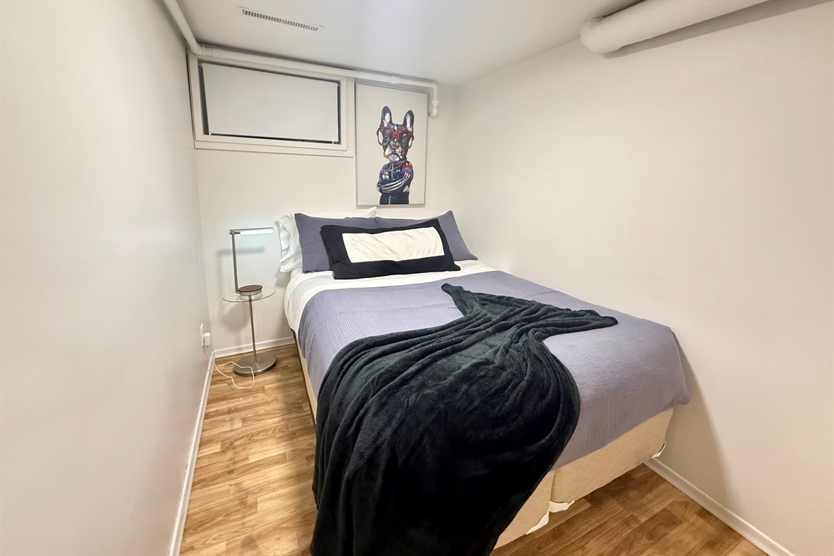 Cozy bedroom with a comfortable double (full 54" wide) bed. As with many 1940s homes, ceiling height is lower in some areas.