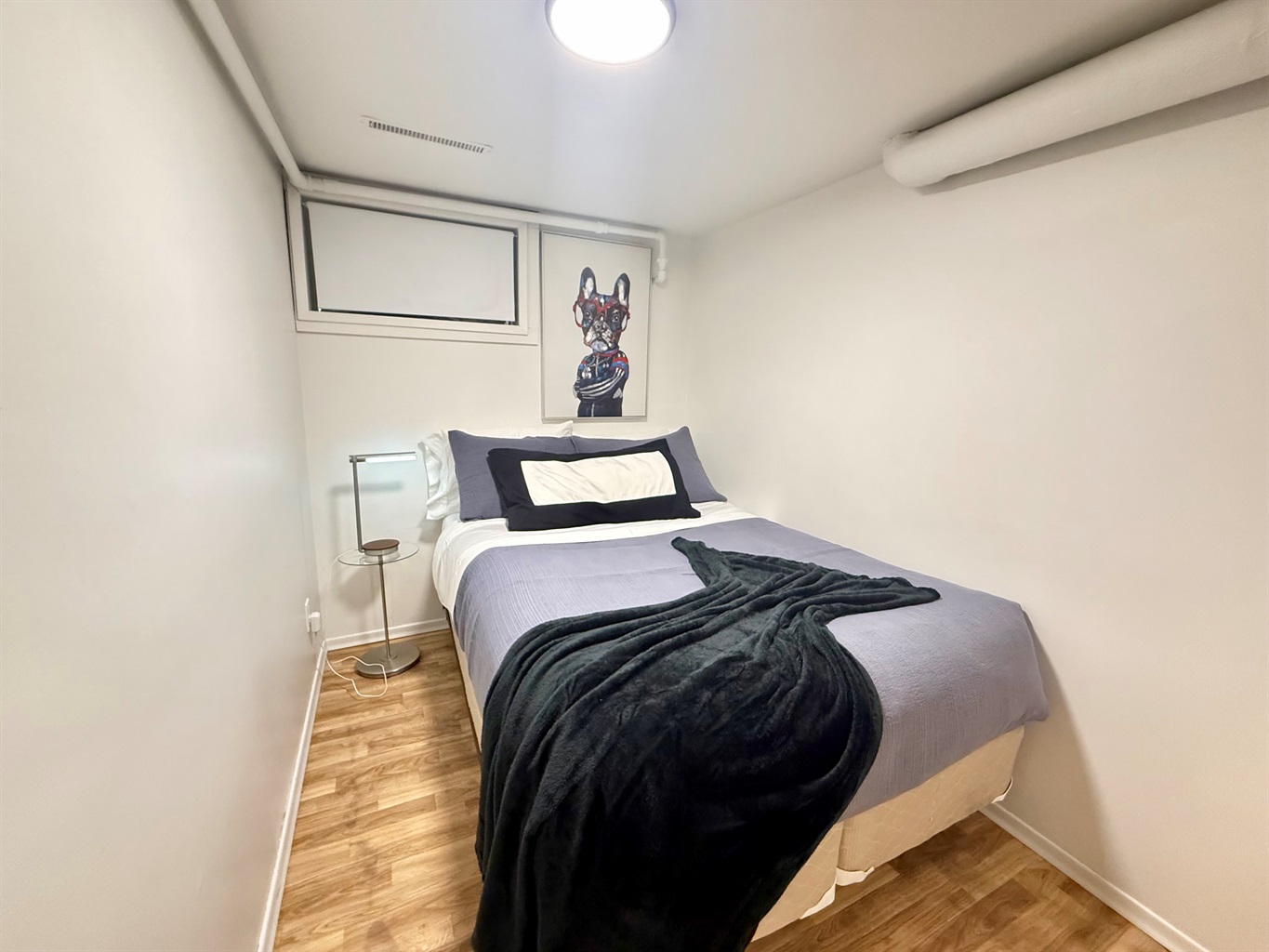 Cozy bedroom with a comfortable double (full 54" wide) bed. As with many 1940s homes, ceiling height is lower in some areas.