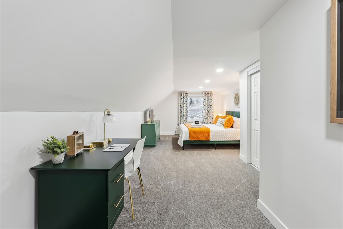 Large bedroom with a designated work area.