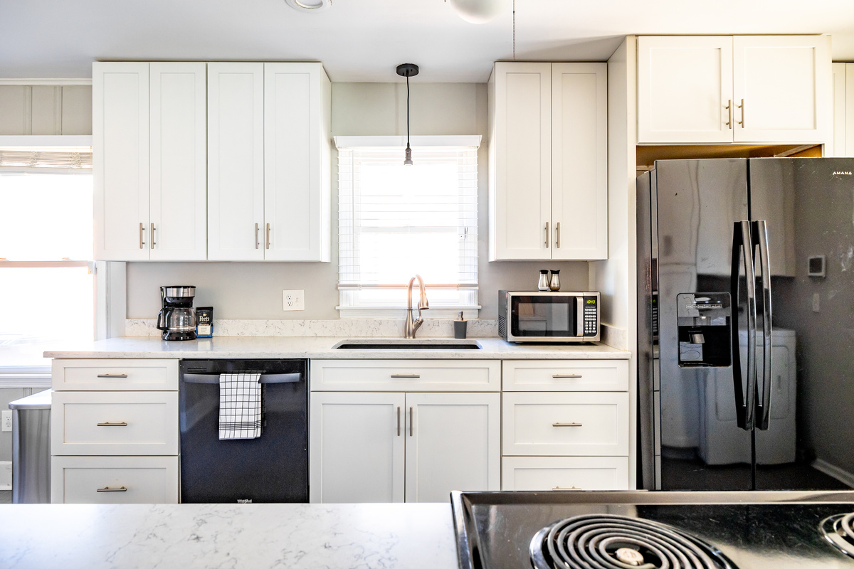 Fully equipped kitchen with refrigerator, stove, oven, microwave, dish washer.
