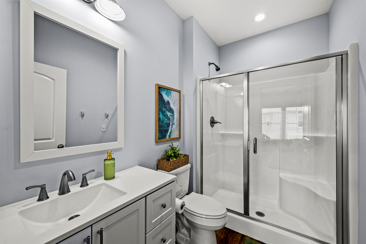 Fresh, modern bathroom with a spacious walk in shower. Perfect for rinsing off after beach days and poolside afternoons.