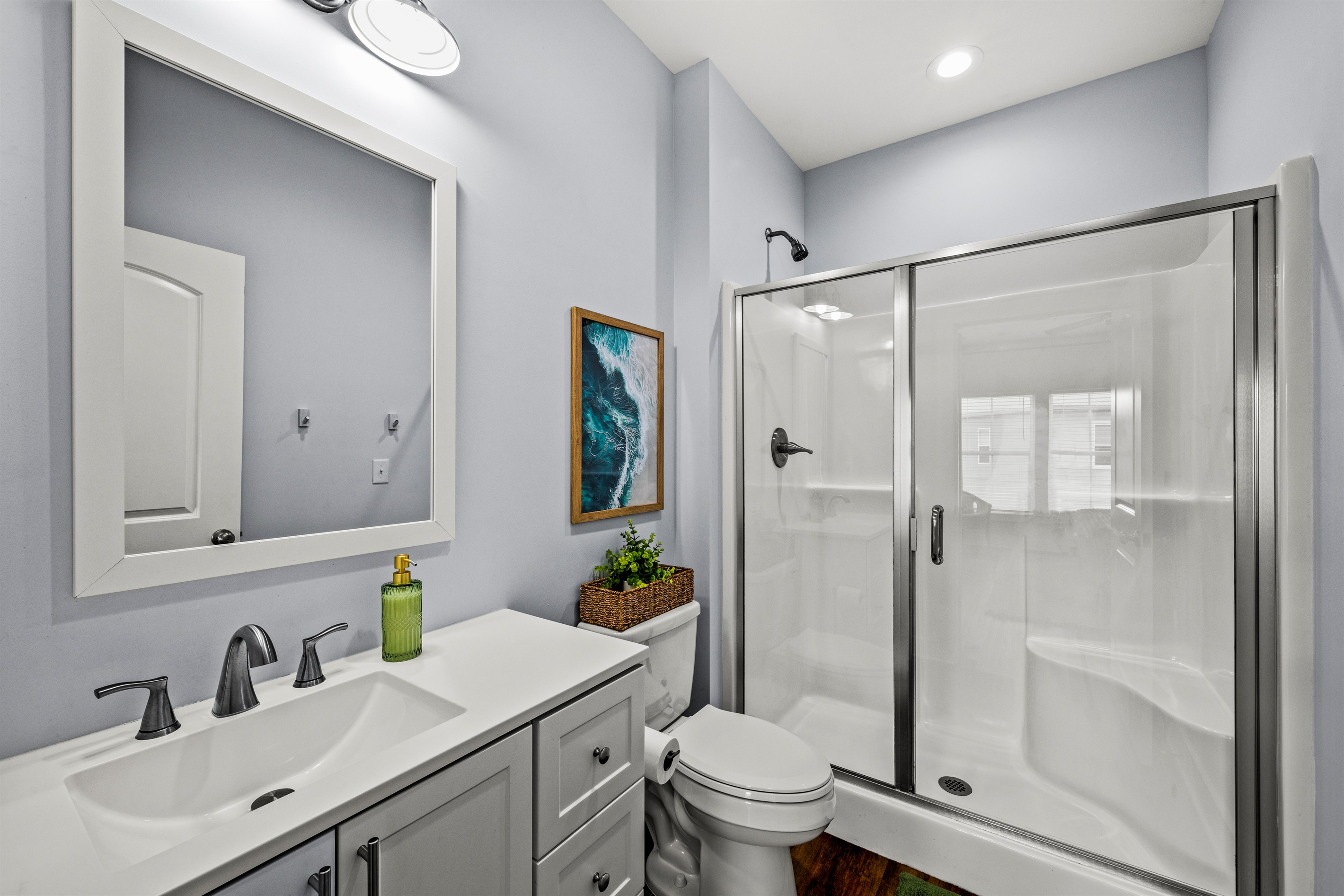 Fresh, modern bathroom with a spacious walk in shower. Perfect for rinsing off after beach days and poolside afternoons.